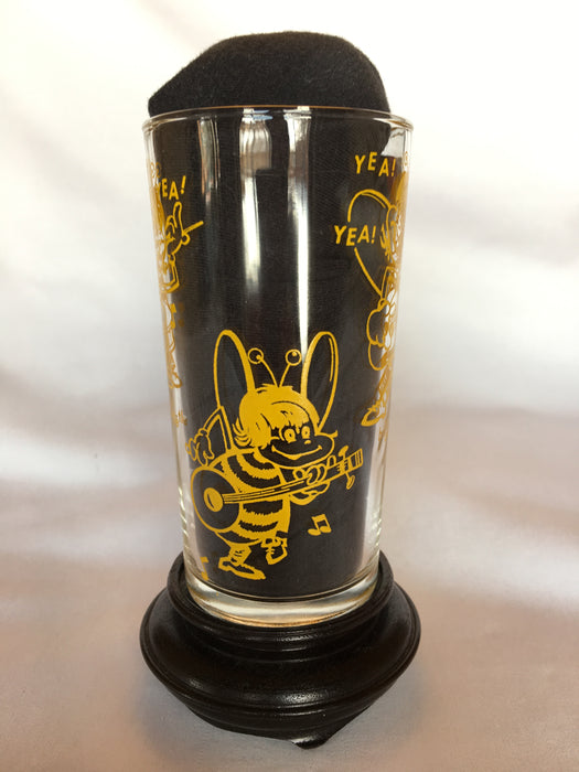 drinking glass with Beatle characters in yellow.